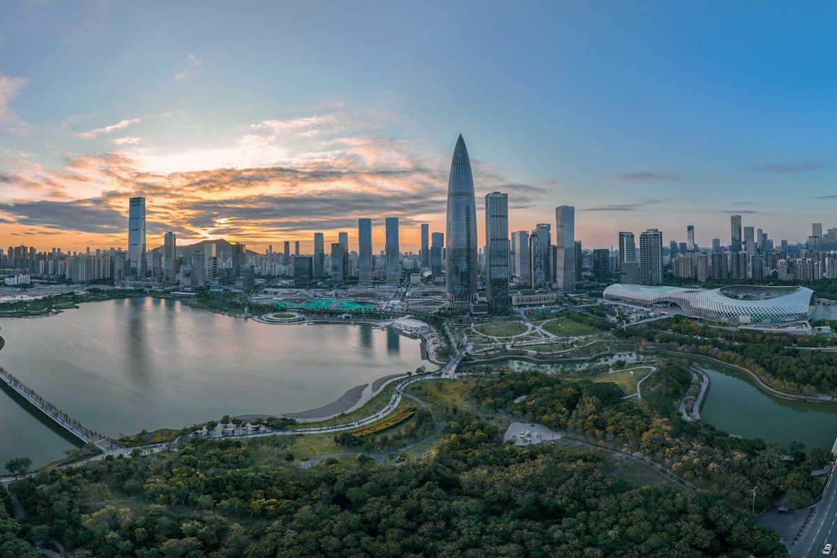 The Shenzhen Bay skyline at sunset, with the China Resources headquarters tower and Shenzhen Bay Sports Centre